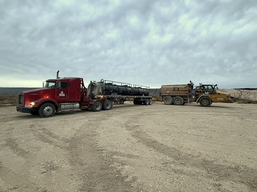 Javelina vacuum truck with heavy equipment