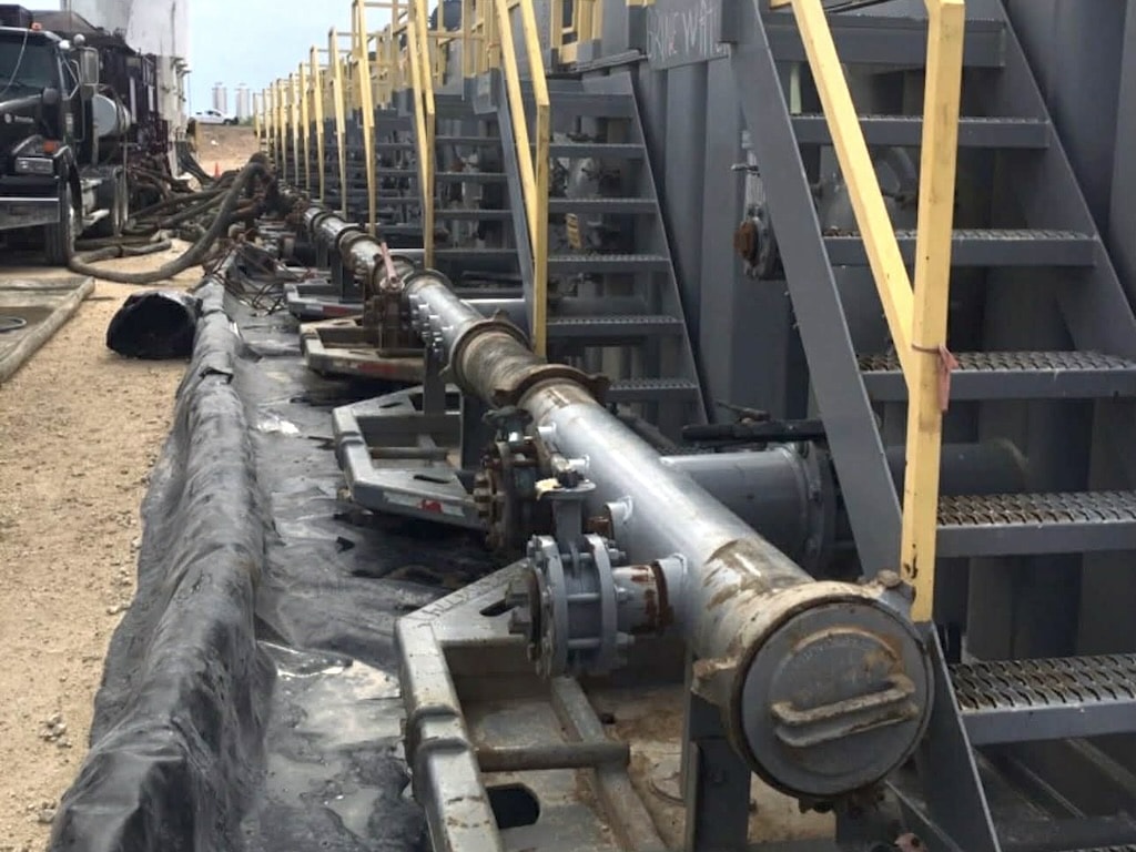 Javelina vacuum truck vacuuming fluid from tanks